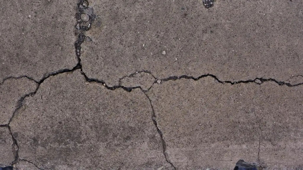 Close-up of a concrete surface with a branching crack running across it